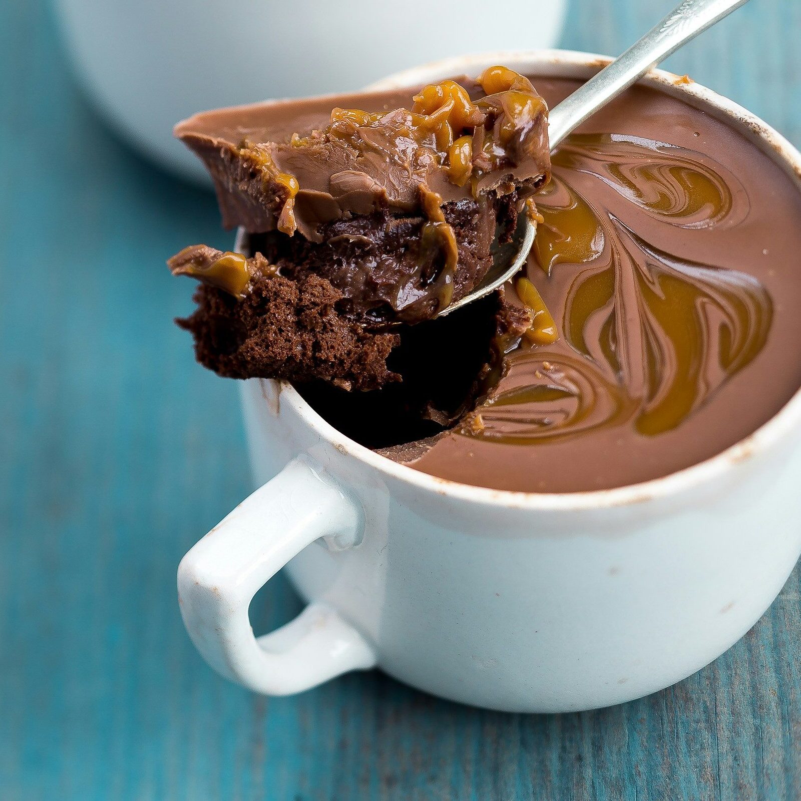 two white ceramic mug with chocolate truffles